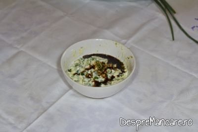 Adaugare picaturi de otet balsamic si firisoare de boia in mujdeiul din usturoi uscat, usturoi verde si iaurt. 